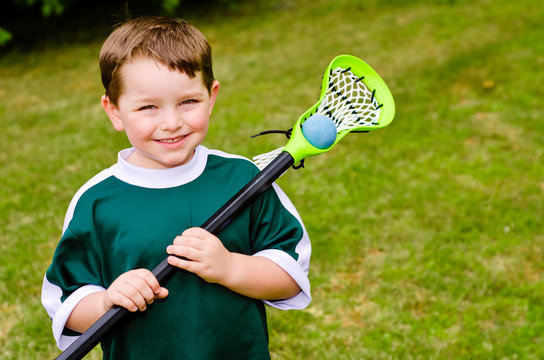 Happy young child lacrosse player with his stick