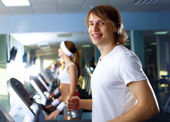 Young man doing sport in gym