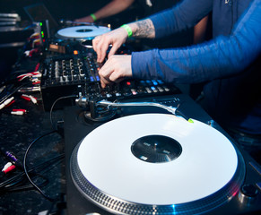 Obraz premium Dj mixes the track in the nightclub
