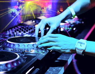 Dj mixes the track in the nightclub