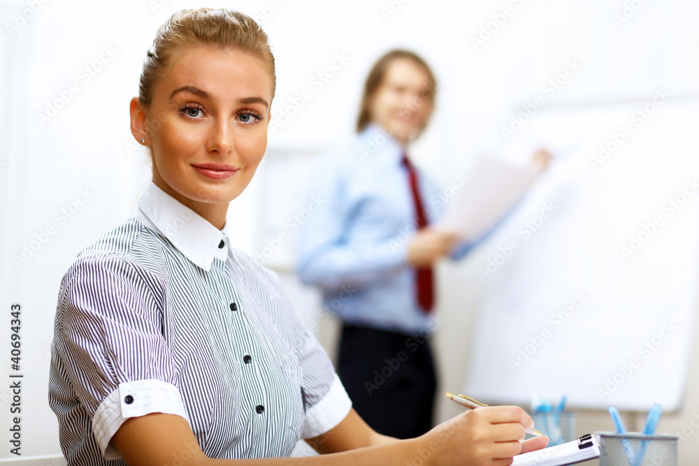 Wall mural Portrait of a business woman in office