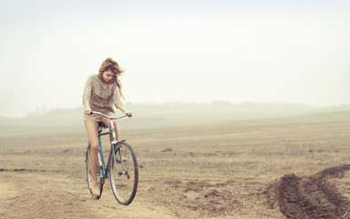 beautiful girl rides a bicycle