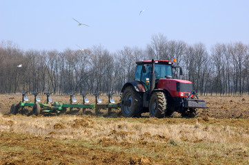 Tractor plowing the new field in spring
