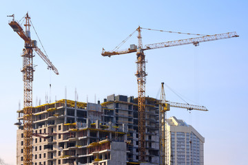 Building cranes and under construction building