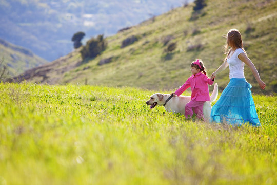 Happy Family Walking With Dog