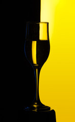Transparent wine glass filled with water black and yellow