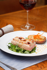 Fried tuna steak and potatoes on the plate