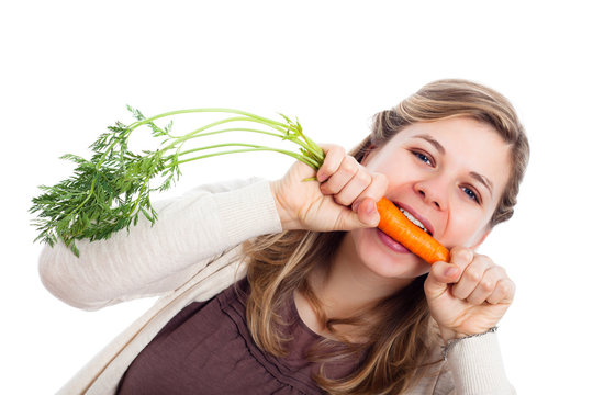 Woman biting carrot