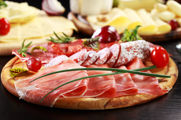 Salami and cheese platter with herbs