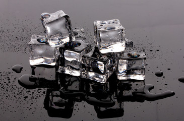 Melting ice cubes on grey background