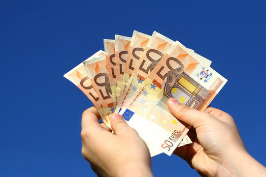 Euro banknotes in woman hand