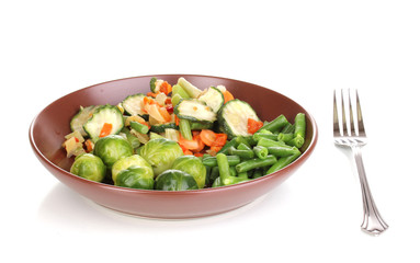 Mixed vegetables on plate isolated on white