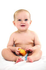 Cute one-year old boy eating cake