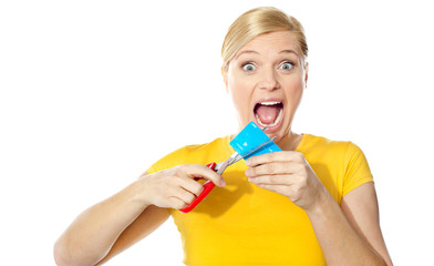 Excited female cutting her credit card