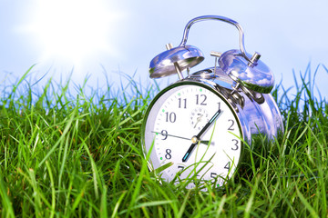 Morning alarm clock on grass