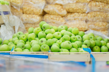 Green apples in box in supermarket