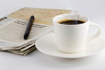 A cup of coffee and a newspaper
