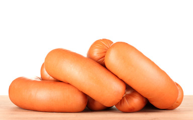 tasty sausages on wooden board isolation on white