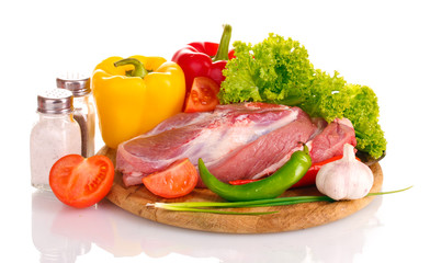 Raw meat and vegetables on a wooden board isolated on whitе