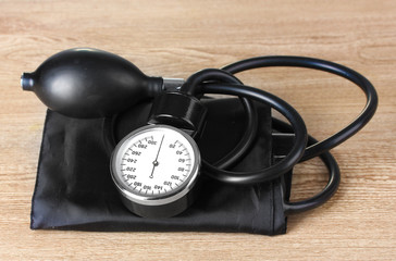 Black tonometer on wooden background