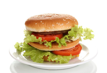 Big and tasty hamburger on plate isolated on white
