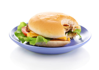 Bitten cheeseburger on plate isolated on white