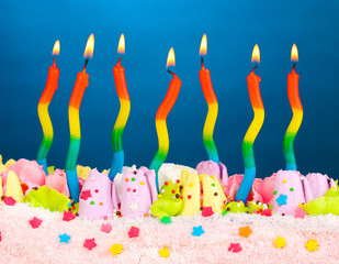 Birthday cake with candles on blue background