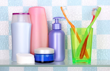 Shelf with cosmetics and toiletries in bathroom