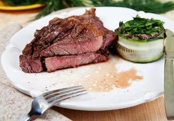 Medium rare rib eye steak cut