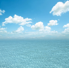 Naklejka na ściany i meble Blue sea with waves and clear blue sky