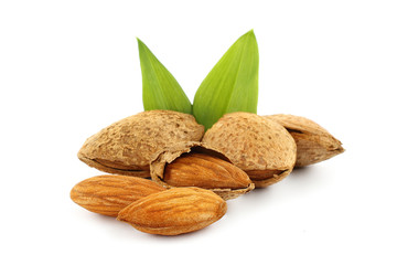 Almonds with green leaves on a white background