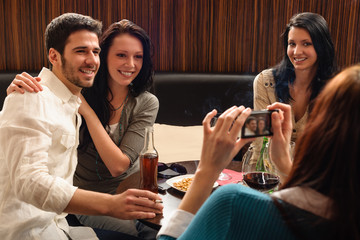 Friends at the bar woman take picture