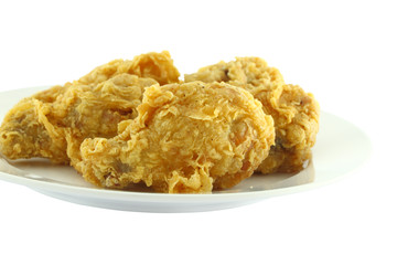 Chicken wing fried focus near dish on white background.