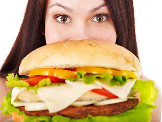 Woman holding hamburger.