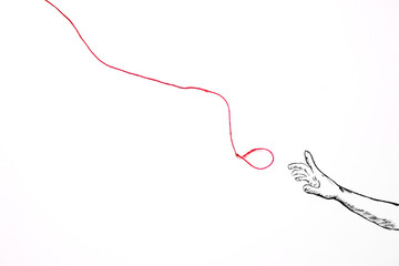 Нand reaching for a red rope with the hope