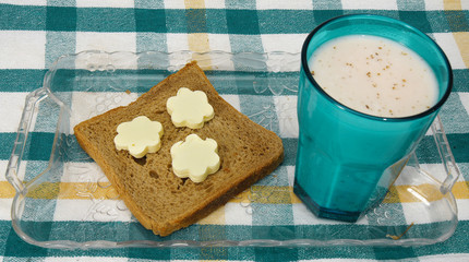 fresh bread, butter in flower shape, and chocolate milk