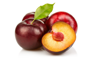 Ripe plums fruit with slices isolated on white