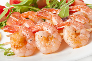 Fresh grilled shrimps with lemon on white plate