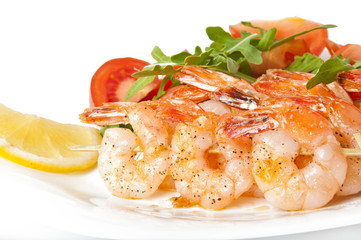Fresh grilled shrimps with lemon on white plate