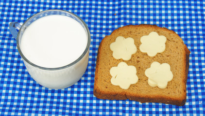 cup of milk and bread with cheese in flower shape