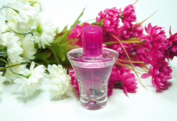 perfume and little flowers behind it