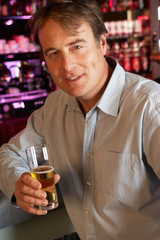 Man Enjoying Drink At Bar