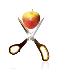 The scissors and red apple
