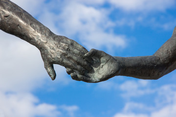 hand holding statues
