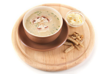 Tasty soup on wooden round board isolated on white