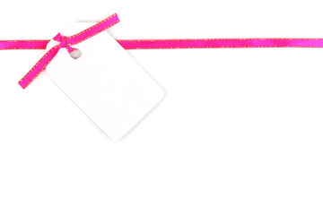 Blank gift tag with pink satin ribbon isolated on white