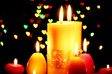 Beautiful candle and decor on wooden table on bright background
