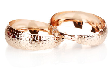 Pair of golden earrings in the shape of the rings isolated