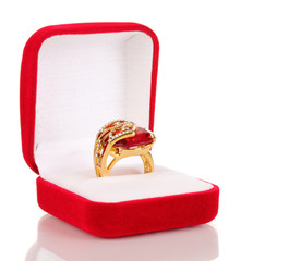 Gold ring with big red gem and clear crystals in red velvet box