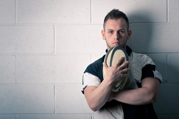 Rugby player against white wall. - 40757540